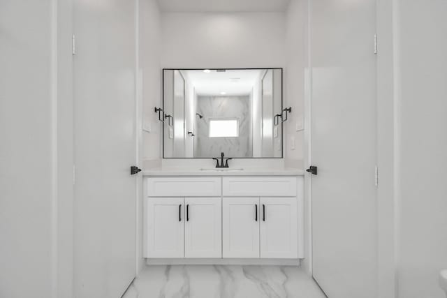 bathroom with walk in shower and vanity