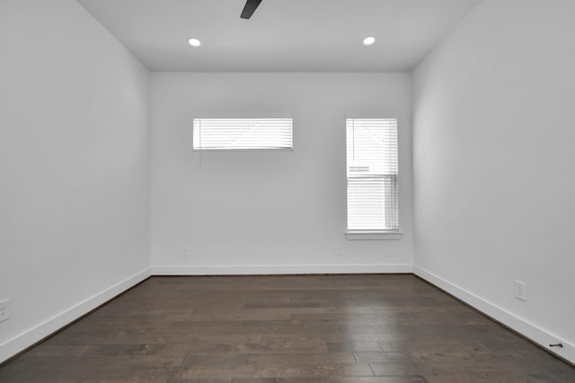 empty room with dark hardwood / wood-style flooring