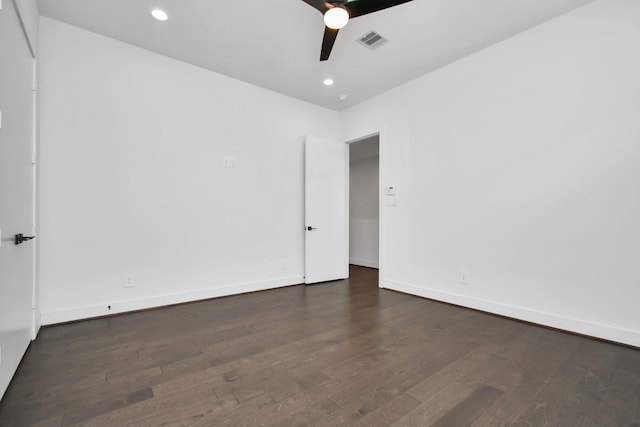 empty room with ceiling fan and dark wood-type flooring