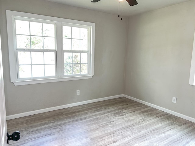 empty room featuring light wood-type flooring and ceiling fan