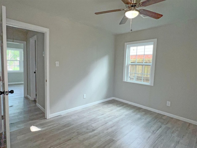 unfurnished room with ceiling fan and light wood-type flooring