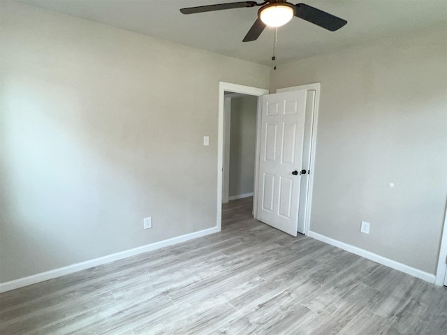 spare room with light hardwood / wood-style floors and ceiling fan