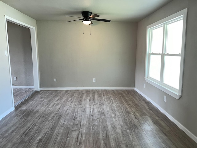 unfurnished room with ceiling fan and dark wood-type flooring