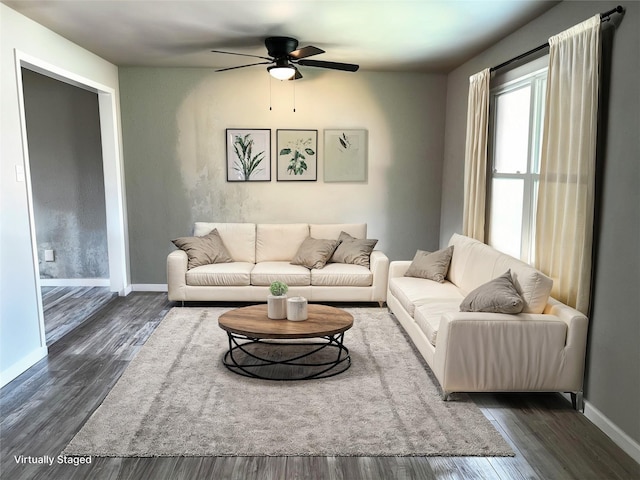 living room with ceiling fan and dark wood-type flooring