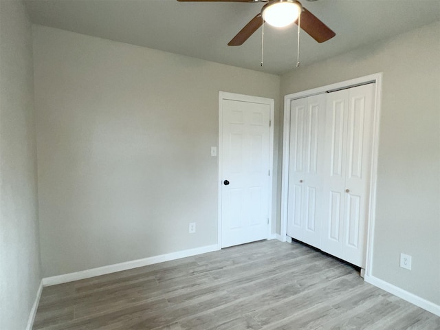 unfurnished bedroom with a closet, ceiling fan, and light hardwood / wood-style floors