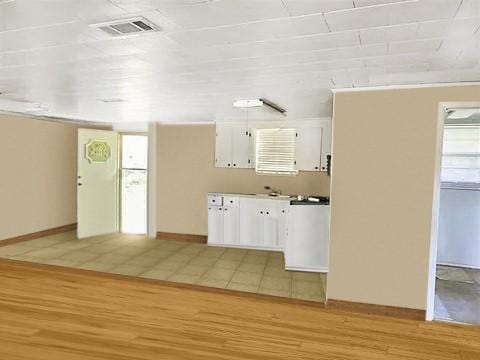 kitchen featuring white cabinetry and light wood-type flooring