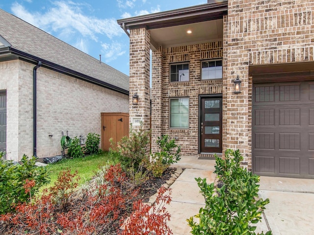 doorway to property with a garage