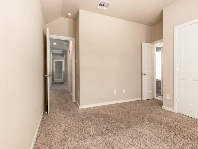 unfurnished bedroom with lofted ceiling and carpet floors