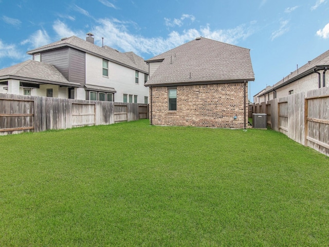 back of property featuring cooling unit and a lawn