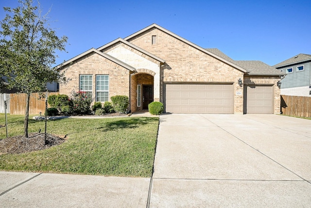 ranch-style home with a garage and a front yard