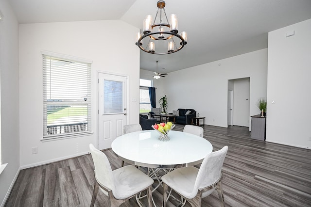 dining room featuring dark wood-type flooring, lofted ceiling, and ceiling fan with notable chandelier