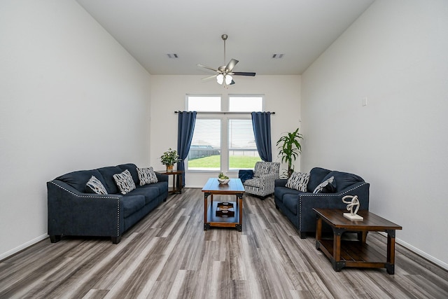 living room with ceiling fan and hardwood / wood-style flooring