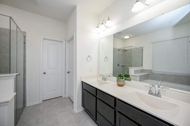 bathroom with independent shower and bath, tile patterned floors, and vanity