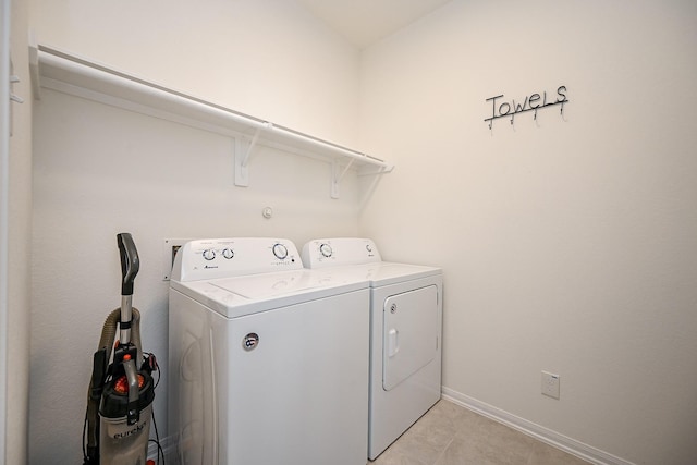 laundry area featuring separate washer and dryer and light tile patterned flooring