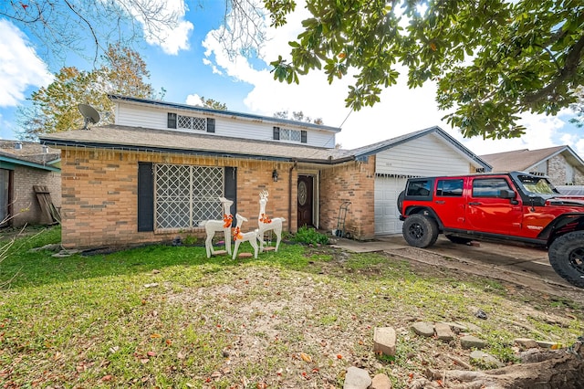 front facade featuring a front lawn and a garage