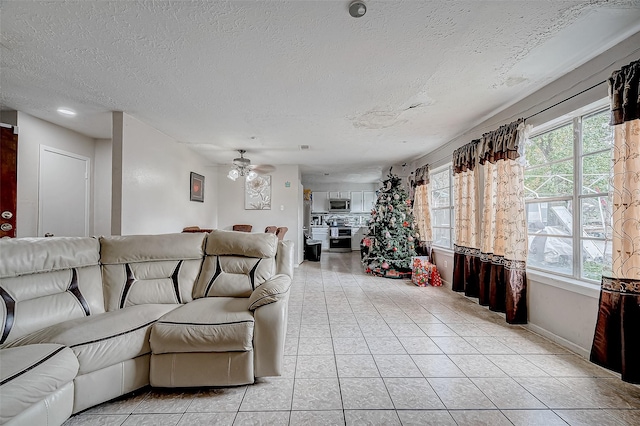 tiled living room with a textured ceiling and ceiling fan