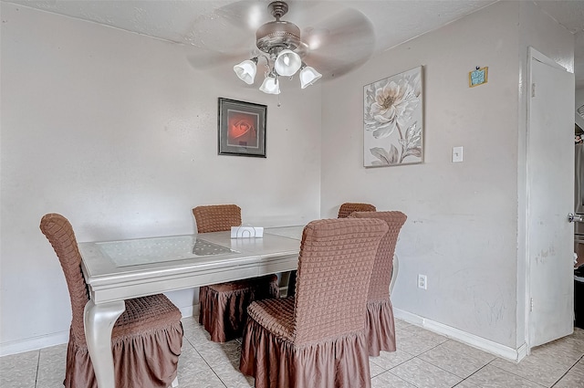 dining space with ceiling fan and light tile patterned floors