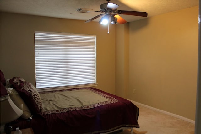 bedroom featuring light colored carpet and ceiling fan