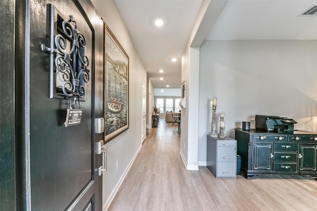 hall with light hardwood / wood-style floors