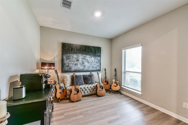 living area with plenty of natural light and light wood-type flooring