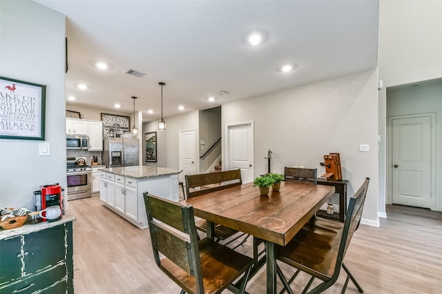 dining room with light wood-type flooring