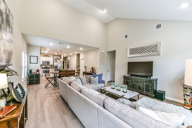 living room featuring light hardwood / wood-style flooring and lofted ceiling