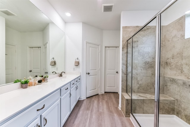 bathroom featuring vanity, hardwood / wood-style flooring, and an enclosed shower