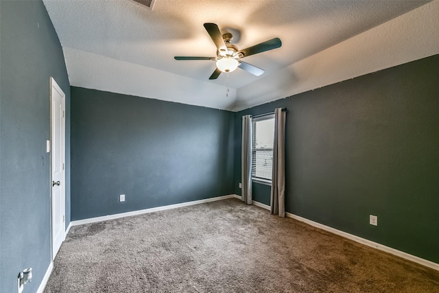 carpeted empty room featuring ceiling fan, a textured ceiling, and lofted ceiling