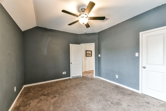 carpeted empty room with ceiling fan and lofted ceiling