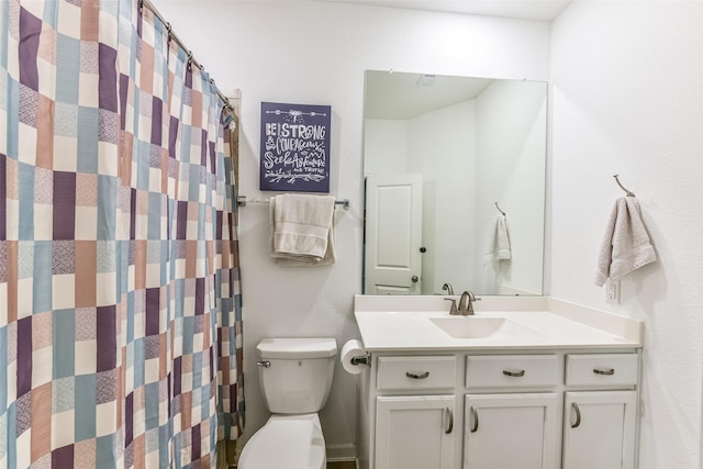 bathroom featuring toilet and vanity