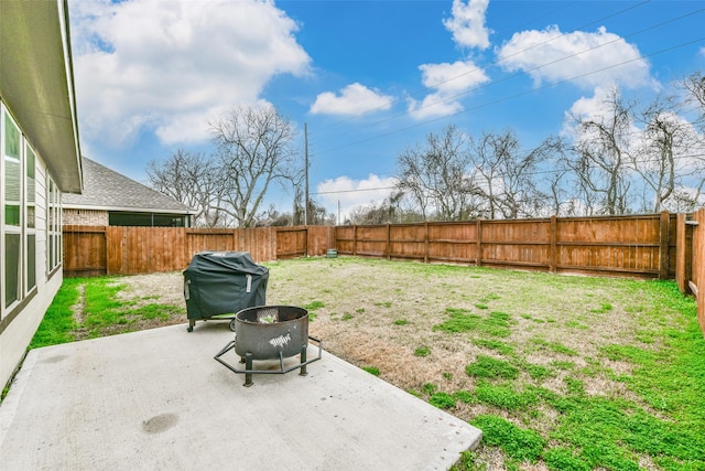 view of yard featuring an outdoor fire pit and a patio