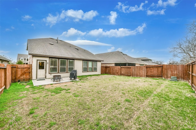 back of house with a patio area and a lawn