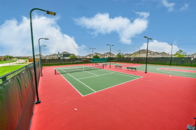 view of tennis court with basketball hoop