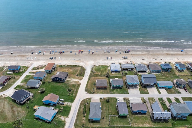 birds eye view of property with a beach view and a water view