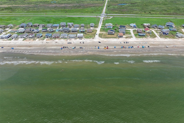 birds eye view of property with a beach view and a water view