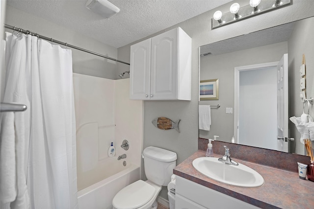 full bathroom featuring toilet, vanity, a textured ceiling, and shower / bath combination with curtain