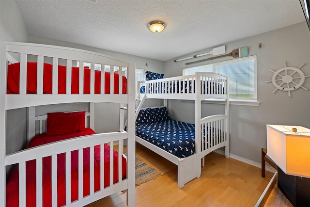 bedroom featuring a textured ceiling and hardwood / wood-style floors