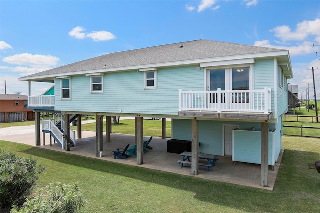 back of house featuring a lawn and a patio area