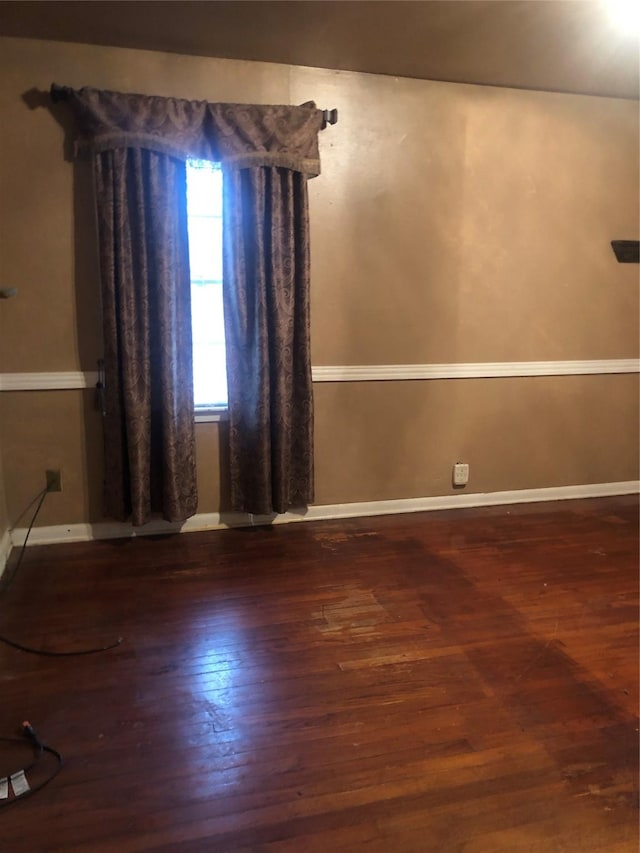 empty room with dark wood-type flooring