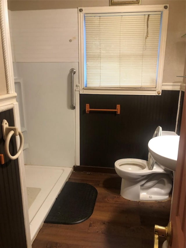 bathroom with toilet, a shower, sink, and hardwood / wood-style floors