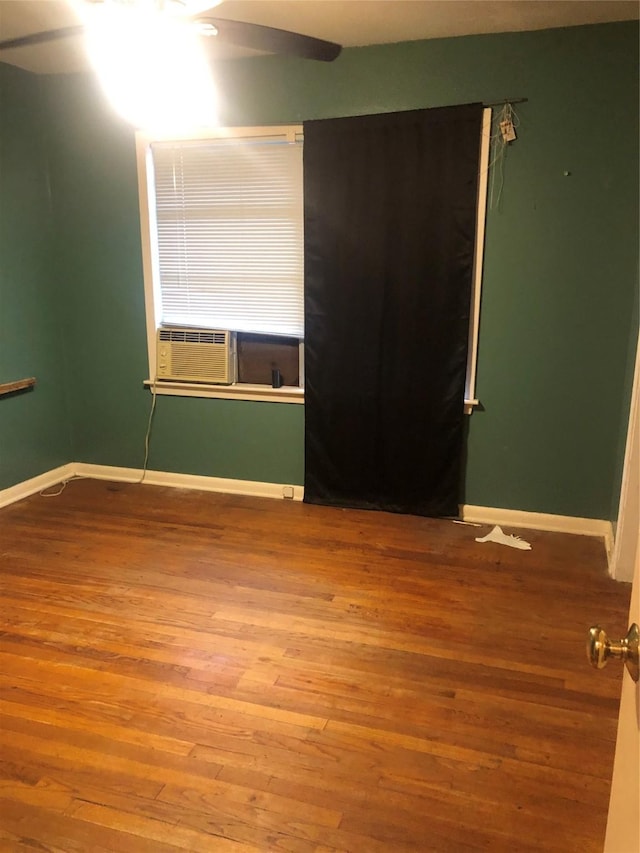 unfurnished room with ceiling fan, cooling unit, and hardwood / wood-style flooring