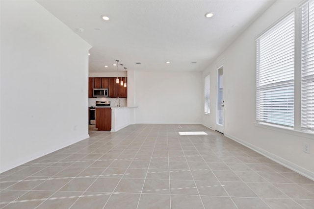 unfurnished living room featuring light tile patterned flooring