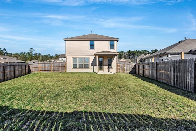 back of house with a lawn