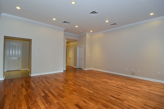 empty room with ornamental molding and light hardwood / wood-style flooring