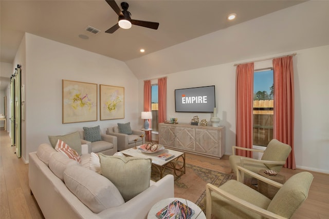 living room with lofted ceiling, light wood-type flooring, and ceiling fan