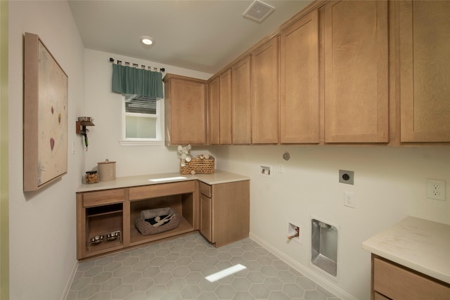 laundry area featuring hookup for a washing machine, cabinets, hookup for an electric dryer, light tile patterned floors, and hookup for a gas dryer