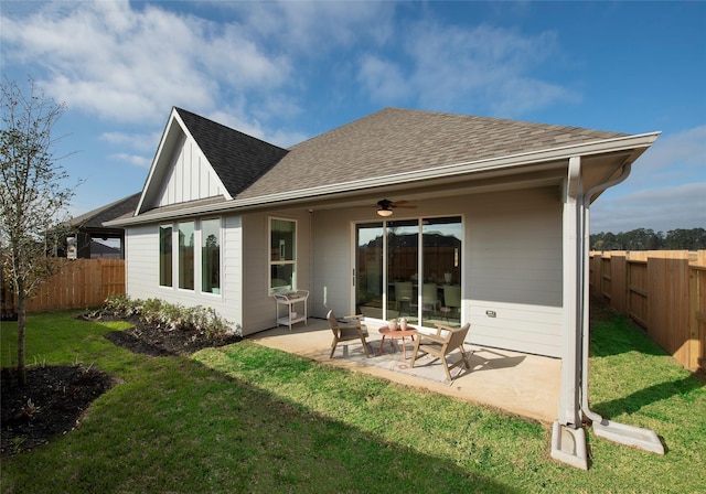 rear view of house featuring a patio area, ceiling fan, and a lawn