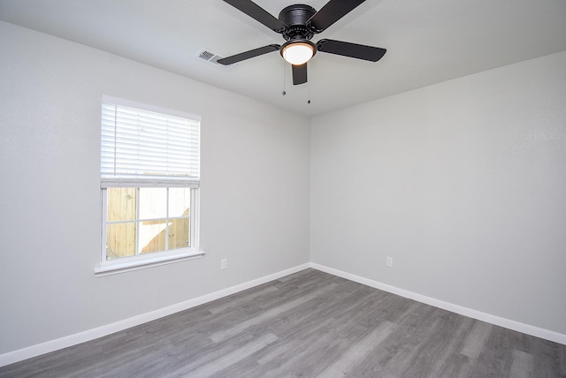 unfurnished room with ceiling fan, hardwood / wood-style floors, and plenty of natural light