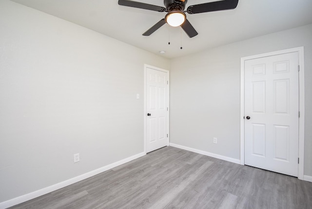 unfurnished bedroom with light wood-type flooring and ceiling fan