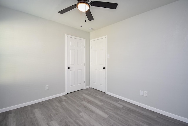 unfurnished room featuring ceiling fan and hardwood / wood-style floors